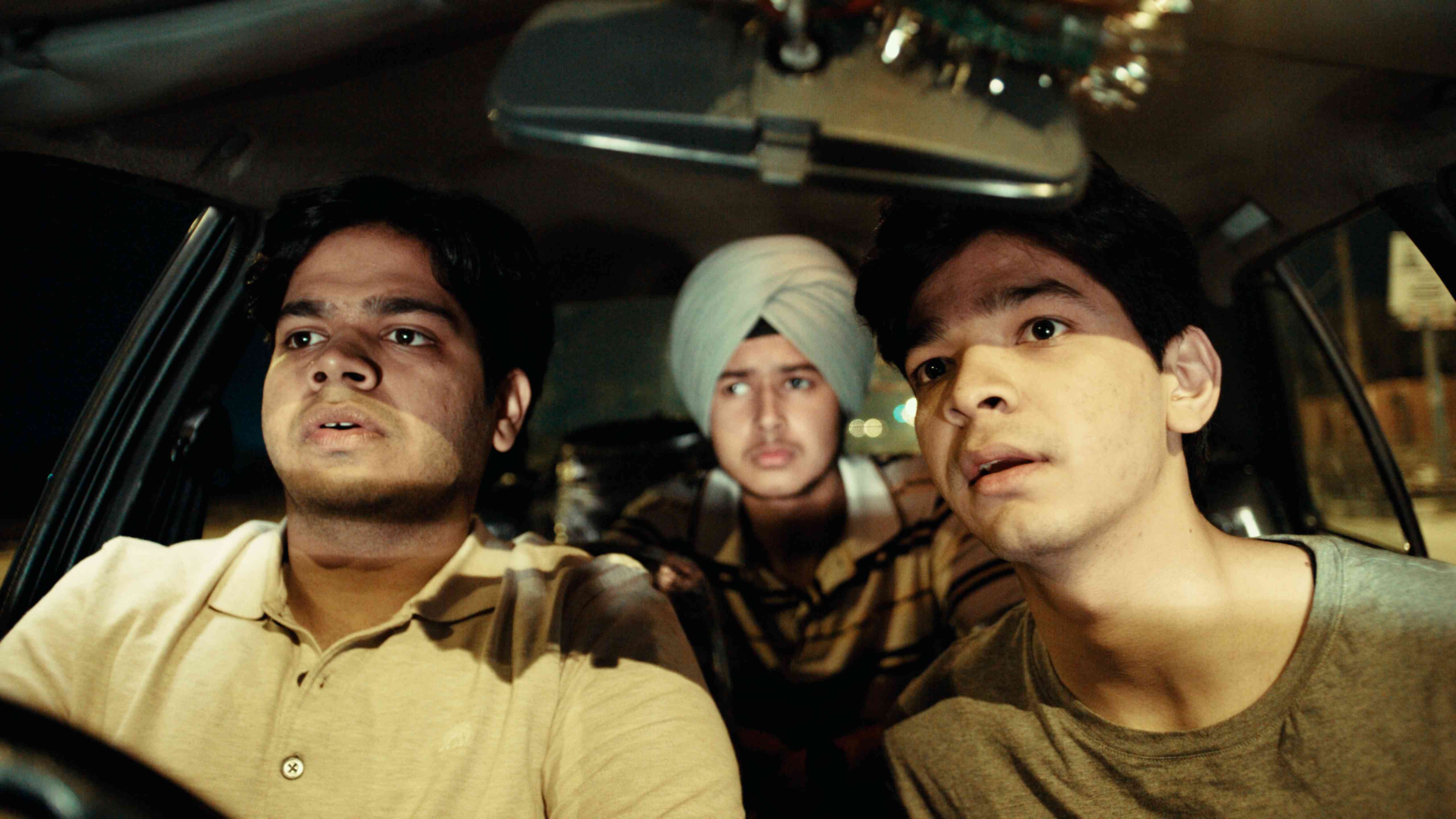 Three friends in a car, embarking on a journey through 90s Chandigarh