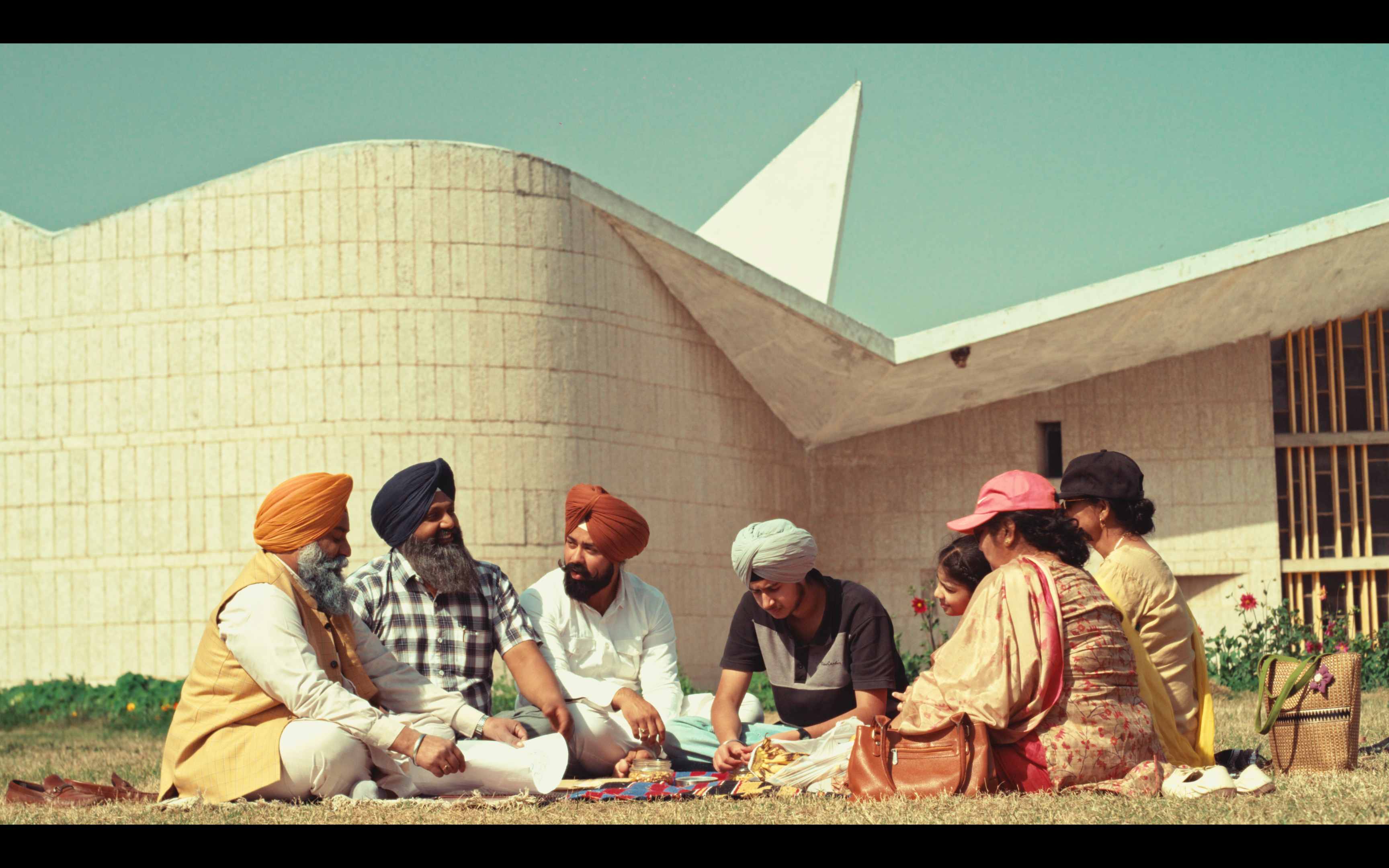 Family gathering outside a modernist building in Chandigarh